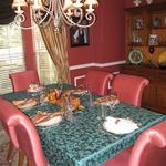 (BEFORE) Dining room with dated Red walls and trim below the chair rail